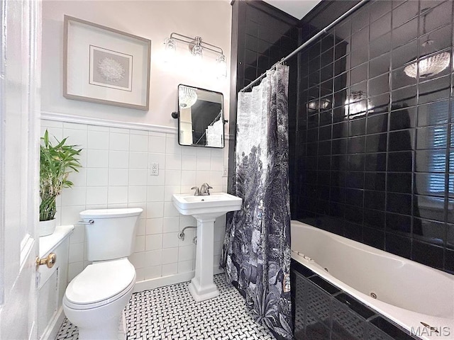 445 E 12th St, Alton, IL 62002 - bathroom featuring tile walls, toilet, tiled shower / bath combo, and wainscoting
