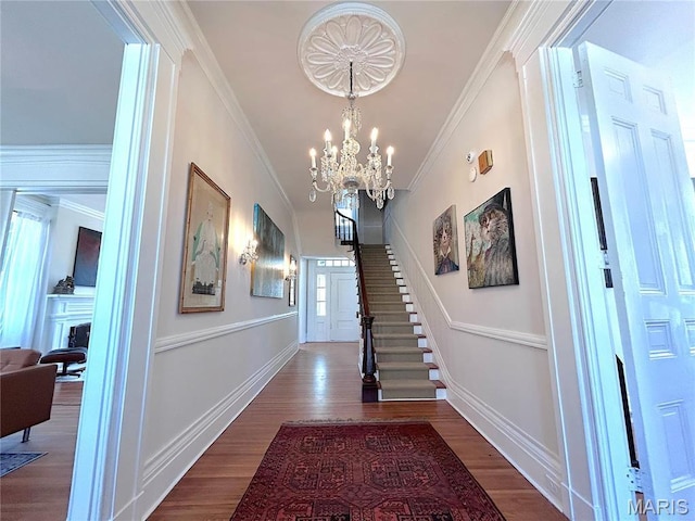445 E 12th St, Alton, IL 62002 - hallway with a chandelier, wood finished floors, ornamental molding, baseboards, and stairs