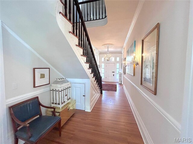 445 E 12th St, Alton, IL 62002 - foyer featuring crown molding, stairway, a chandelier, and wood finished floors