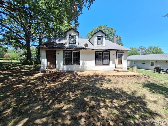 view of front of property featuring a chimney and a patio