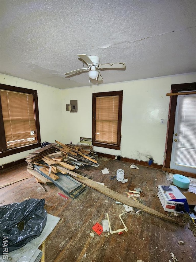 unfurnished living room featuring a textured ceiling and ceiling fan
