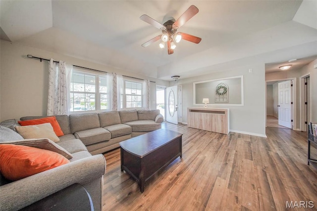19580 Lyle Ln, Waynesville, MO 65583 - living area featuring a ceiling fan, wood finished floors, a tray ceiling, and baseboards