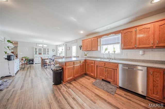 19580 Lyle Ln, Waynesville, MO 65583 - kitchen with dishwasher, a sink, light wood-type flooring, a peninsula, and a chandelier