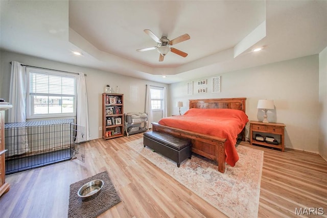 19580 Lyle Ln, Waynesville, MO 65583 - bedroom featuring a tray ceiling, light wood-type flooring, recessed lighting, and ceiling fan