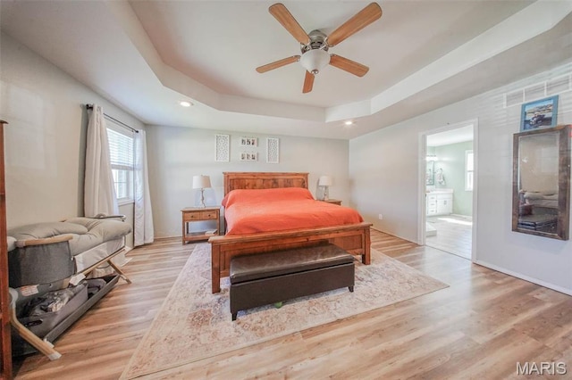 19580 Lyle Ln, Waynesville, MO 65583 - bedroom featuring a tray ceiling, light wood-type flooring, ensuite bath, recessed lighting, and baseboards