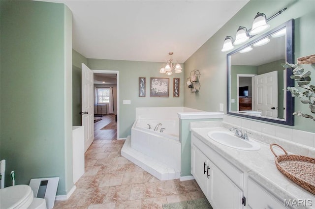 19580 Lyle Ln, Waynesville, MO 65583 - full bathroom with a chandelier, a bath, vanity, stone finish floors, and baseboards