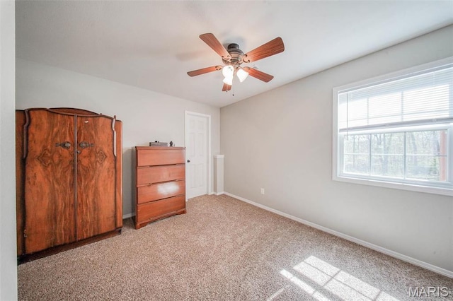 19580 Lyle Ln, Waynesville, MO 65583 - unfurnished bedroom featuring baseboards, light colored carpet, and a ceiling fan
