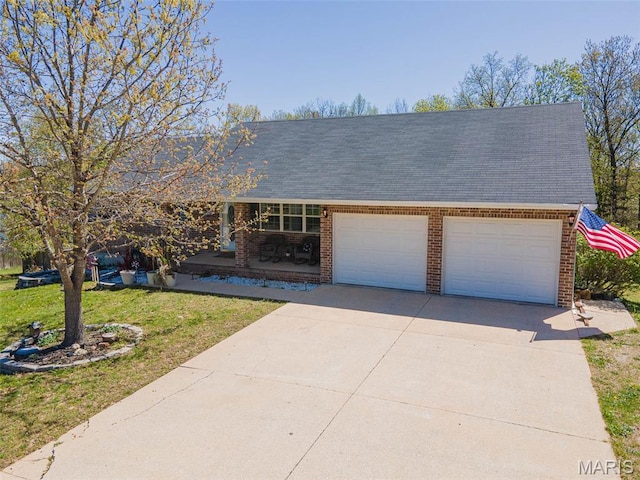 19580 Lyle Ln, Waynesville, MO 65583 - view of front of home featuring a porch, brick siding, a front lawn, an attached garage, and concrete driveway