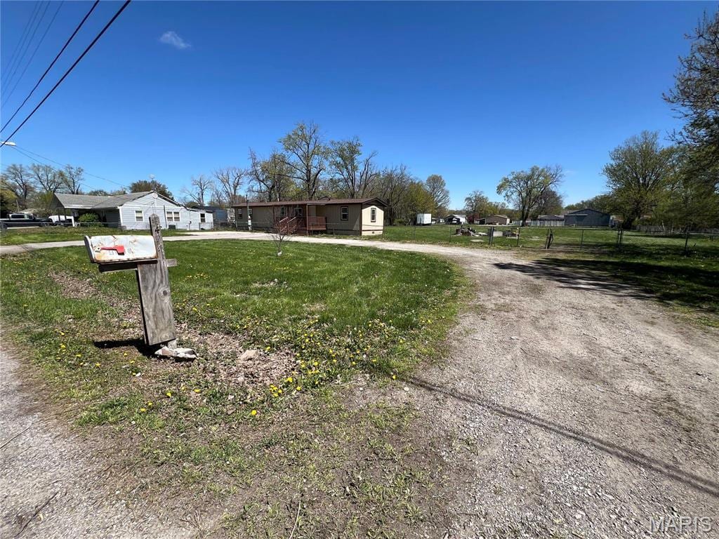 4118 Division St, Granite City, IL 62040 - view of front of house with dirt driveway and a front yard