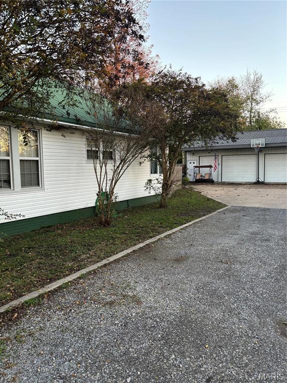 111 W Broadway St, Hayti, MO 63851 - view of home's exterior featuring driveway and metal roof