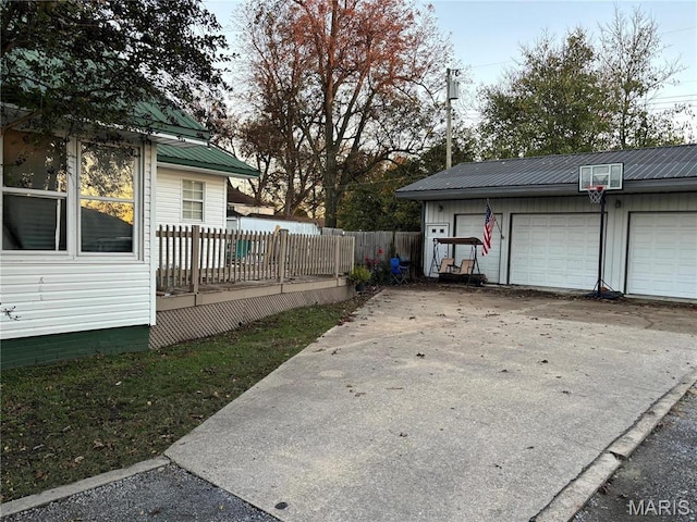 111 W Broadway St, Hayti, MO 63851 - view of property exterior with metal roof, an outbuilding, fence, and a garage