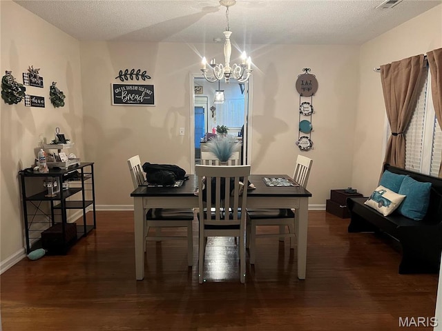 111 W Broadway St, Hayti, MO 63851 - dining space featuring a chandelier, wood finished floors, a textured ceiling, and baseboards