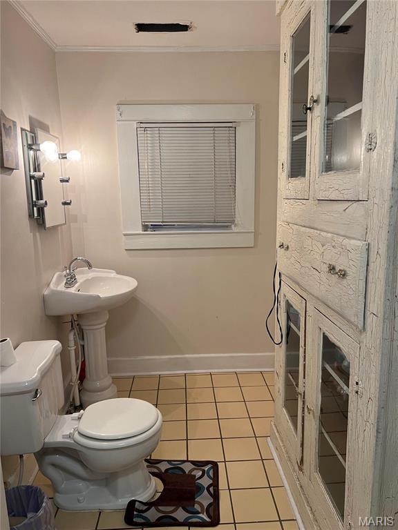 111 W Broadway St, Hayti, MO 63851 - bathroom with toilet, ornamental molding, tile patterned flooring, and baseboards