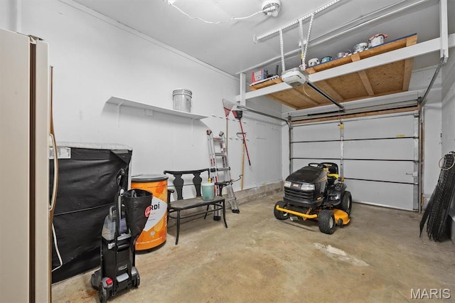 garage featuring a garage door opener and freestanding refrigerator