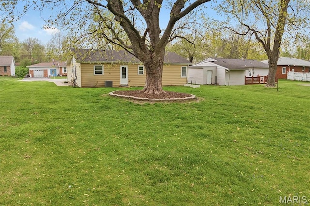 view of grassy yard featuring central air condition unit