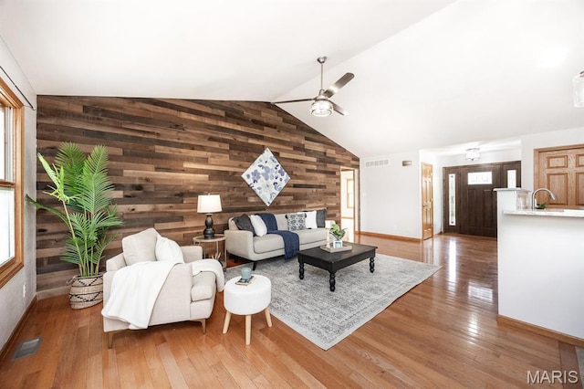 92 Rinderer Rd, Trenton, IL 62293 - living room featuring wood walls, ceiling fan, wood finished floors, baseboards, and plenty of natural light
