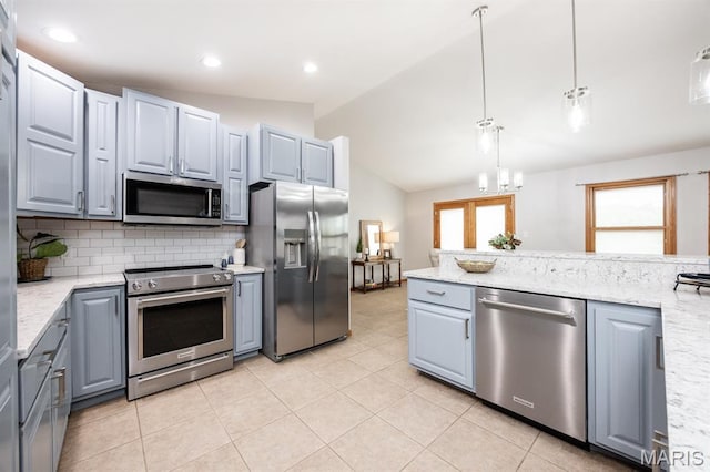 92 Rinderer Rd, Trenton, IL 62293 - kitchen with stainless steel appliances, gray cabinetry, lofted ceiling, tasteful backsplash, and light stone countertops