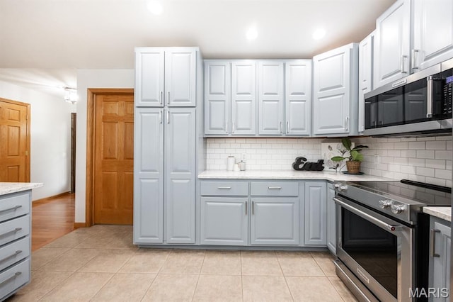 92 Rinderer Rd, Trenton, IL 62293 - kitchen with appliances with stainless steel finishes, gray cabinetry, tasteful backsplash, light tile patterned floors, and recessed lighting