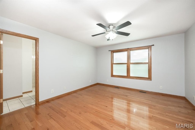 92 Rinderer Rd, Trenton, IL 62293 - unfurnished room with light wood finished floors, a ceiling fan, and baseboards