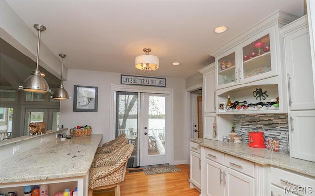 616 W Capri Dr, Bonne Terre, MO 63628 - kitchen featuring open shelves, tasteful backsplash, light wood-style flooring, white cabinets, and french doors