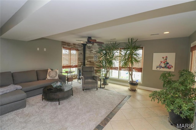 616 W Capri Dr, Bonne Terre, MO 63628 - living area featuring tile patterned floors, a wood stove, baseboards, ceiling fan, and recessed lighting