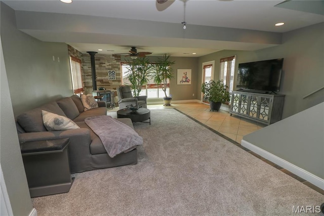 616 W Capri Dr, Bonne Terre, MO 63628 - living room featuring a wood stove, ceiling fan, baseboards, recessed lighting, and tile patterned floors