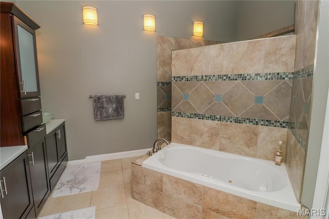 616 W Capri Dr, Bonne Terre, MO 63628 - bathroom with tiled tub, vanity, tile patterned flooring, and baseboards