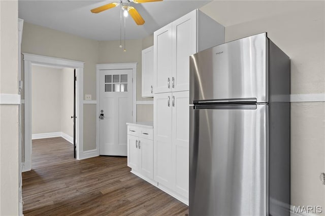 4913 Devonshire Ave, Saint Louis, MO 63109 - kitchen featuring freestanding refrigerator, white cabinetry, dark wood-style floors, ceiling fan, and light countertops
