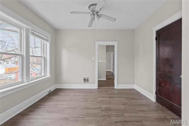 4913 Devonshire Ave, Saint Louis, MO 63109 - spare room with healthy amount of natural light, a ceiling fan, wood finished floors, and baseboards