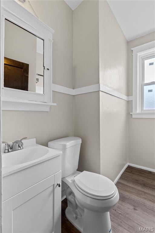 4913 Devonshire Ave, Saint Louis, MO 63109 - half bathroom with toilet, wood finished floors, vanity, and baseboards