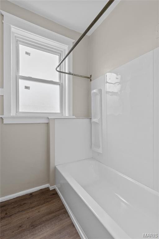 4913 Devonshire Ave, Saint Louis, MO 63109 - bathroom featuring wood finished floors, baseboards, and bathing tub / shower combination
