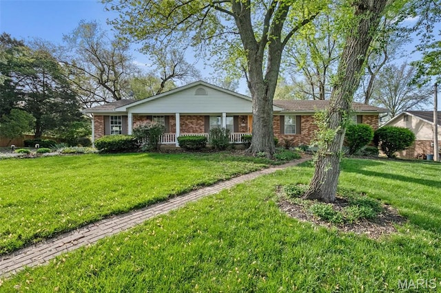 4044 Locke Ave, Bridgeton, MO 63044 - view of front of house with brick siding, a front lawn, and covered porch