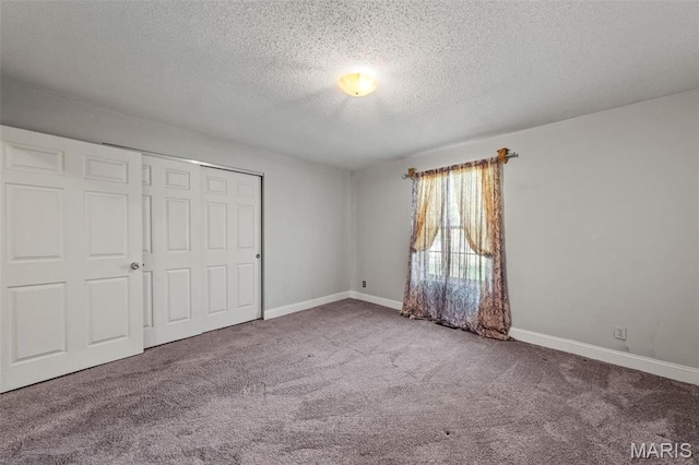 4044 Locke Ave, Bridgeton, MO 63044 - unfurnished bedroom featuring a textured ceiling, carpet floors, a closet, and baseboards