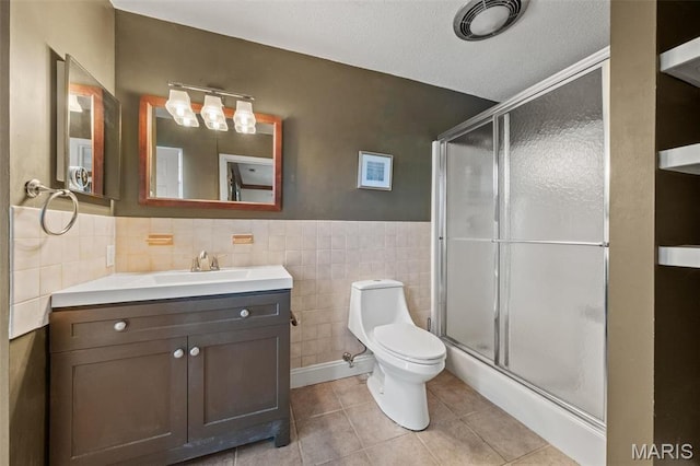 4044 Locke Ave, Bridgeton, MO 63044 - full bathroom with tile walls, tile patterned floors, a shower stall, toilet, and vanity