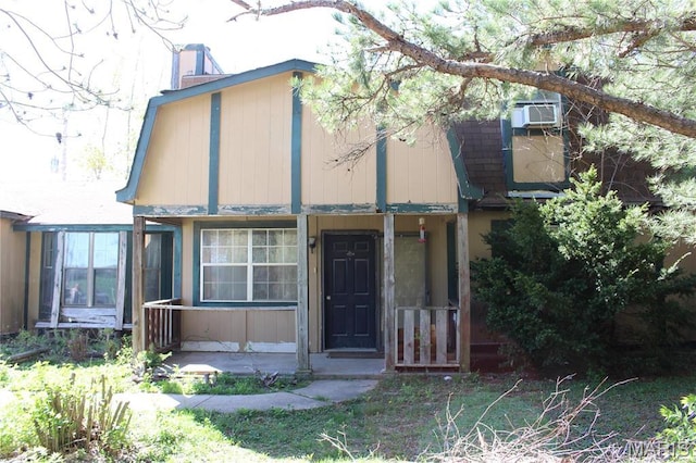 view of front of property with a chimney and covered porch