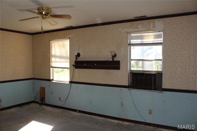 spare room featuring ornamental molding, ceiling fan, and wallpapered walls