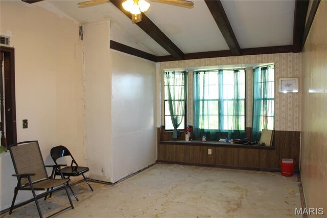 spare room featuring ceiling fan and beamed ceiling