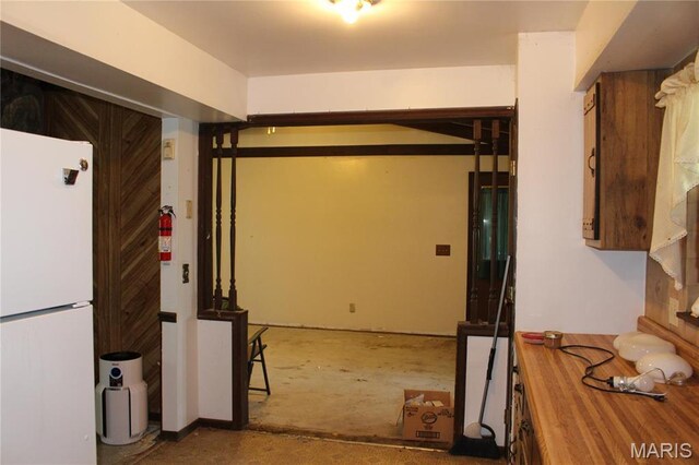 interior space featuring freestanding refrigerator and wooden counters