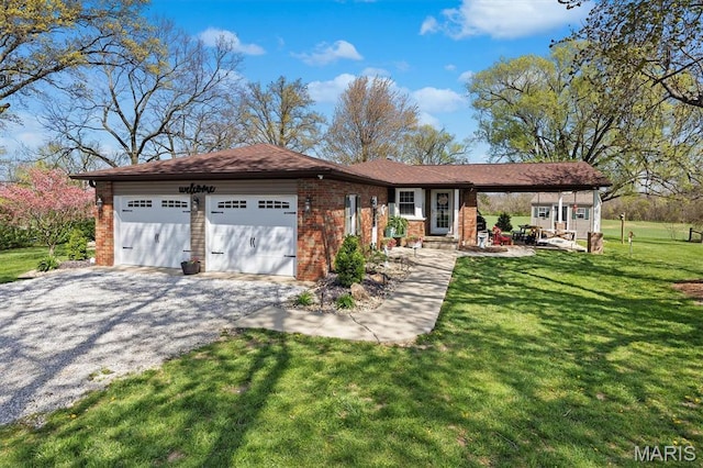 21510 Keyesport Rd, Keyesport, IL 62253 - view of front of home with brick siding, an attached garage, a front yard, and gravel driveway