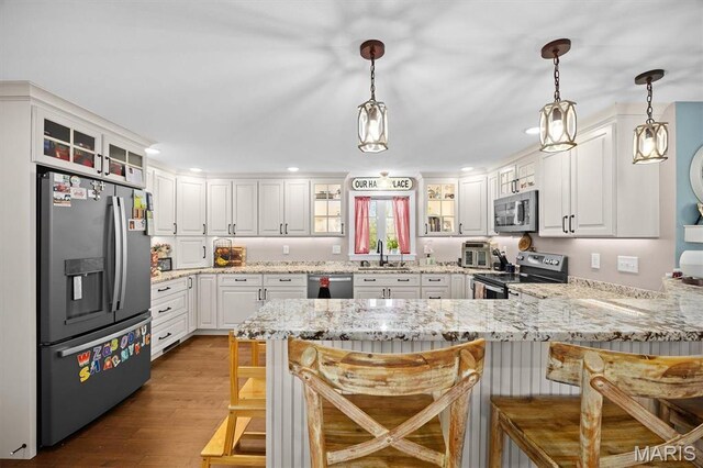 21510 Keyesport Rd, Keyesport, IL 62253 - kitchen featuring appliances with stainless steel finishes, a sink, a peninsula, glass insert cabinets, and recessed lighting