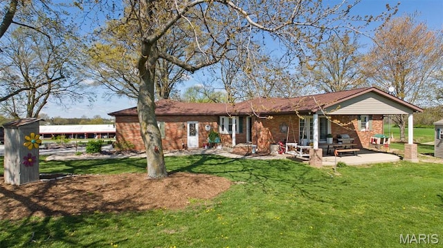 21510 Keyesport Rd, Keyesport, IL 62253 - back of property with brick siding, a lawn, and a patio