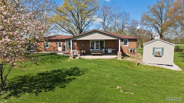 21510 Keyesport Rd, Keyesport, IL 62253 - rear view of house featuring french doors, a yard, a patio area, an outdoor structure, and brick siding