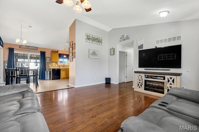 420 Glen Forest Dr, Troy, MO 63379 - living area with vaulted ceiling, a chandelier, a ceiling fan, wood finished floors, and baseboards