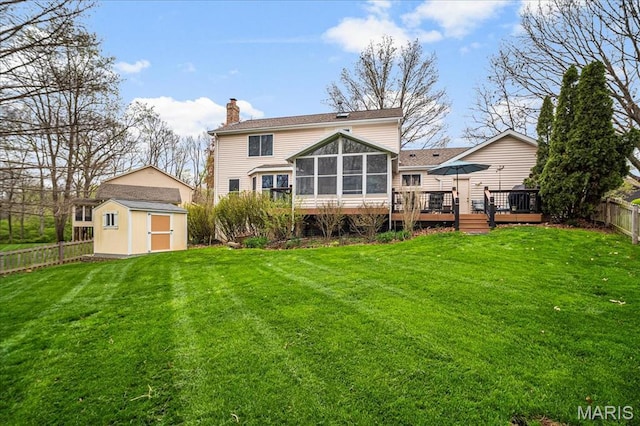 14815 Sycamore Manor Ct, Chesterfield, MO 63017 - back of property with a storage shed, a sunroom, a wooden deck, a chimney, and a fenced backyard