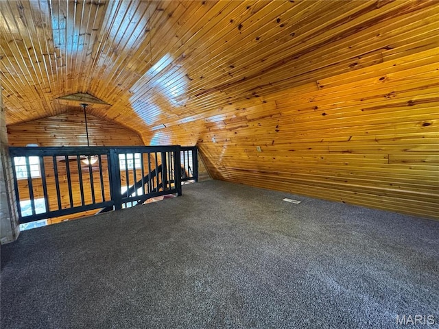 bonus room with lofted ceiling, wood walls, and carpet