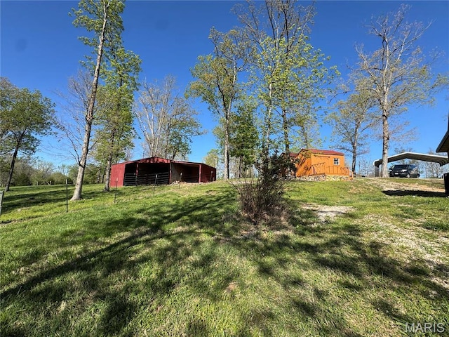 view of green lawn featuring an outbuilding and an outdoor structure