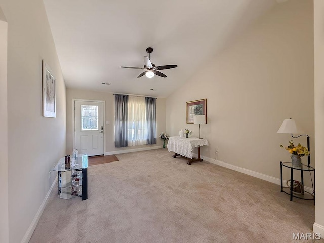 living area with a ceiling fan, carpet floors, baseboards, and lofted ceiling