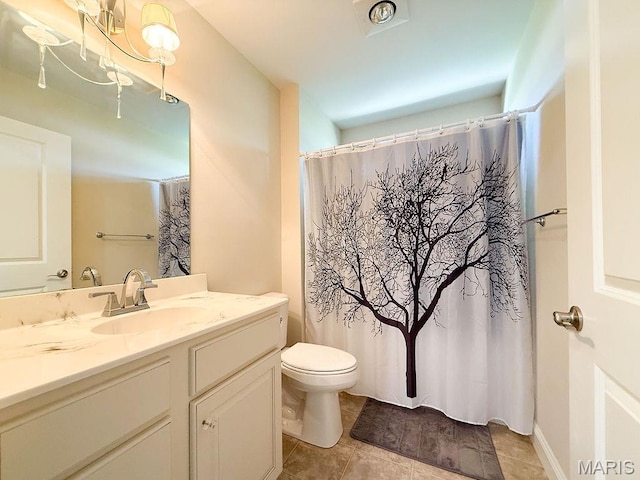 bathroom with tile patterned flooring, toilet, and vanity