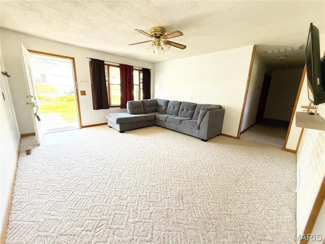 520 Keeton Rd, Rolla, MO 65401 - living room featuring light colored carpet, ceiling fan, a textured ceiling, and baseboards