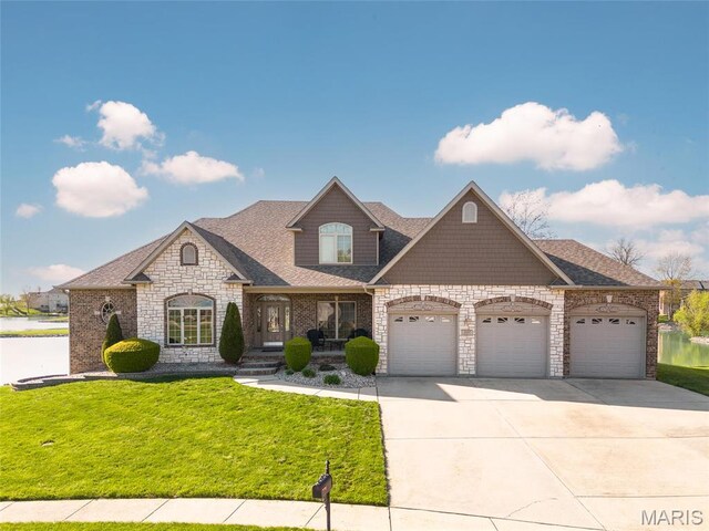 2017 Richview Dr, Saint Jacob, IL 62281 - french country style house with an attached garage, a front yard, stone siding, concrete driveway, and roof with shingles